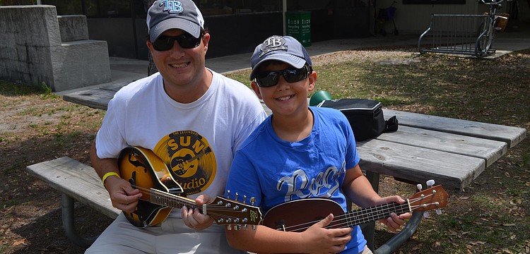 Jon and Jackson Anderson with a ukulele and mandolin.