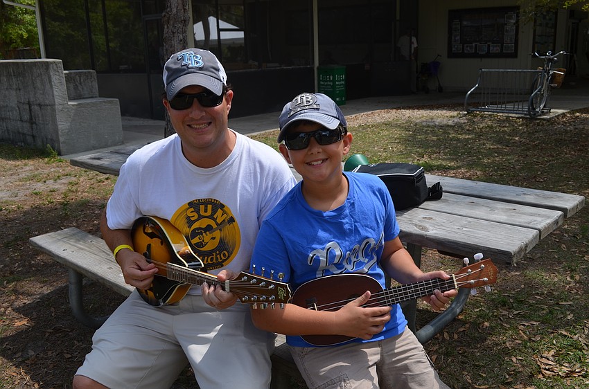 Jon and Jackson Anderson with a ukulele and mandolin.