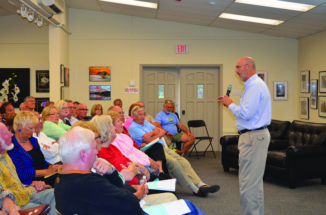 Kurt Schultheis Town Manager Dave Bullock discusses beach erosion issues with more than 100 people who attended a North End Coalition of Property Owners meeting March 20, at the Longboat Key Center for the Arts.
