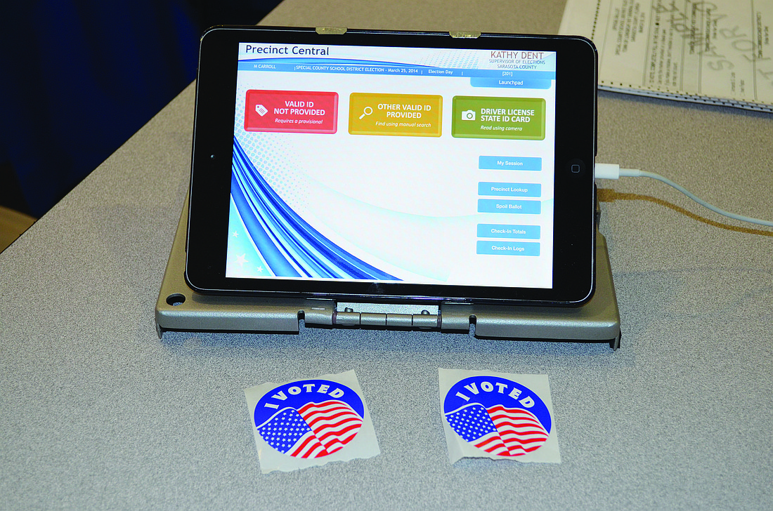 Sarasota County Supervisor of Elections volunteers used three new electronic pollbooks to sign in registered voters at Town Hall on Tuesday.