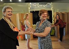Friends Janet Davis and Lois Kummery learn a latin dance as part of the dayâ€™s festivities