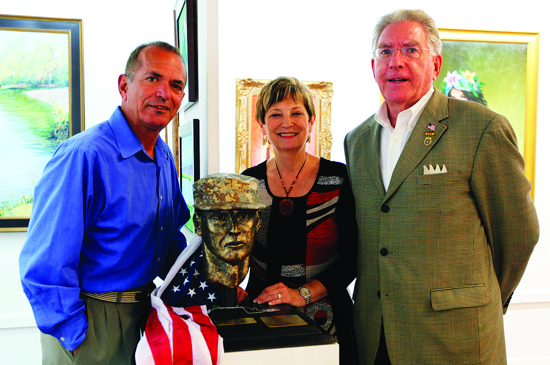Kelsey Grau Gene Sweeney, Bonnie Chisling and Russ Carthy with Chisling's sculpture, "Tribute to the Everyday Soldier."