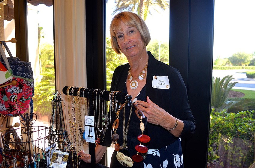 Linda McGrath runs a jewelry booth.