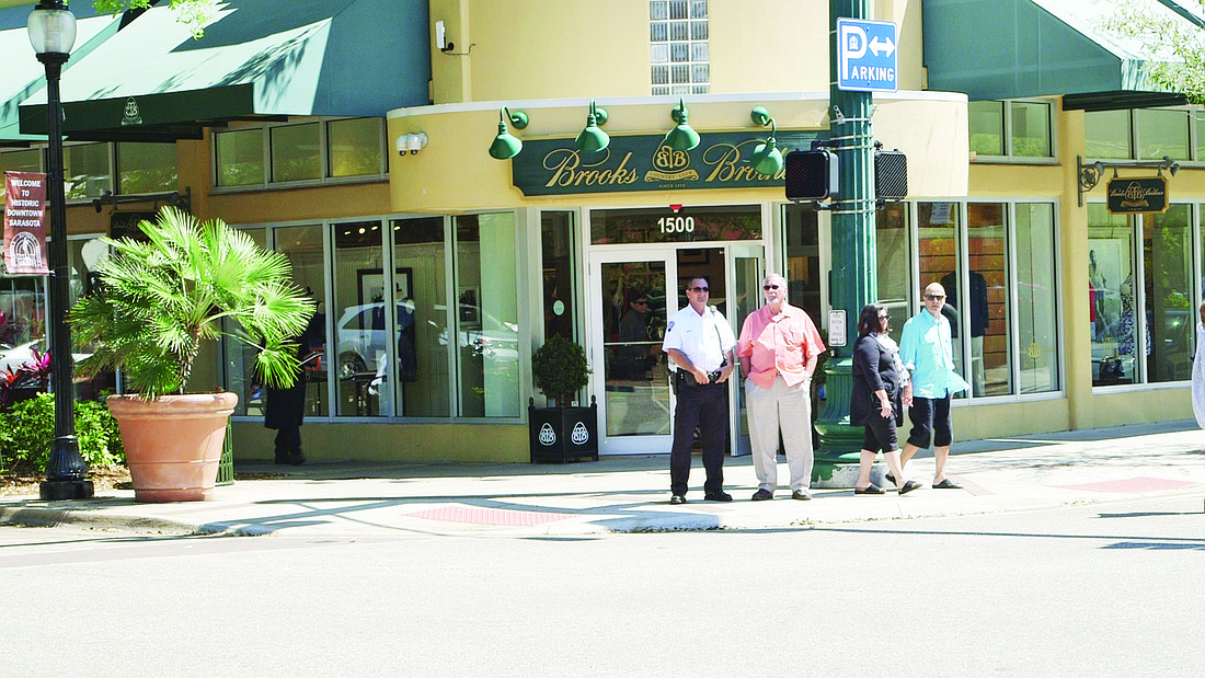 Security guards monitor businesses at Lemon Square, including Brooks Brothers. (Photo by Colin Reid)
