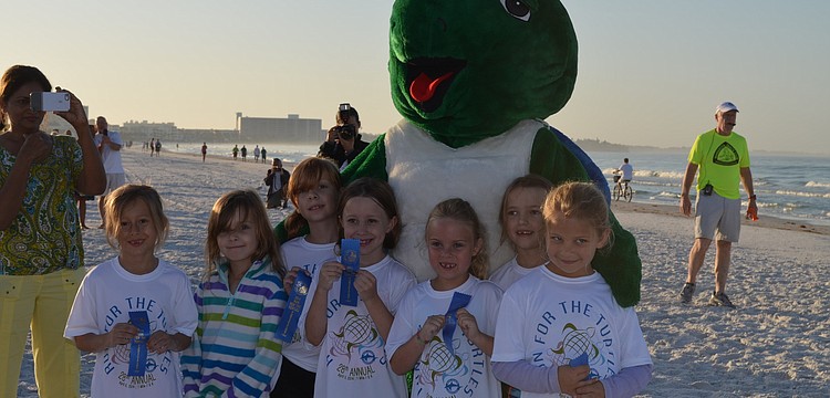 Daisy Troop 304 show off their blue ribbons after the 1-Mile Fun Run.