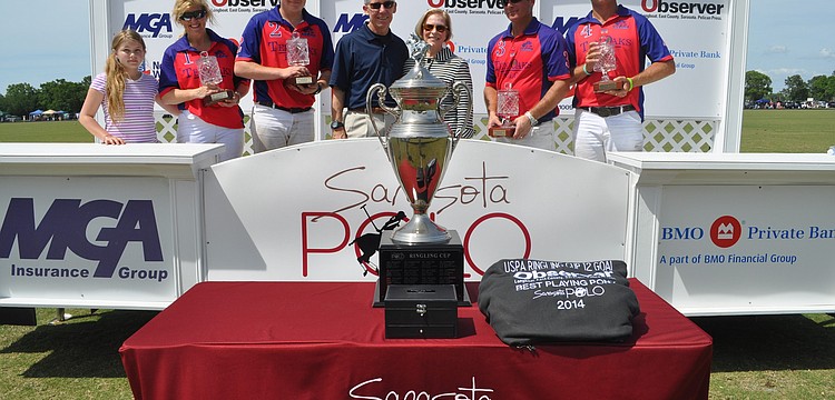 The winning team, Ten Oaks Polo, poses with Matt and Lisa Walsh of the Observer Media Group.