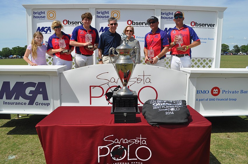 The winning team, Ten Oaks Polo, poses with Matt and Lisa Walsh of the Observer Media Group.