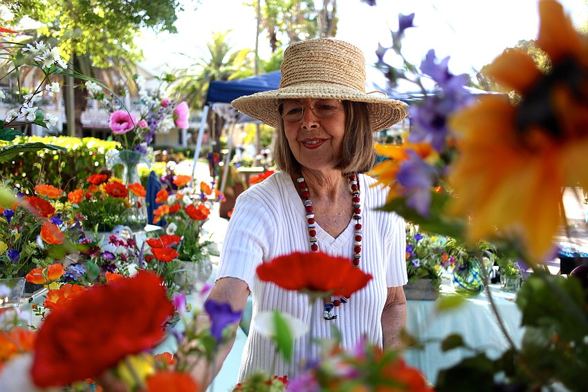 Bonita Mertes arranges her â€œperpetualâ€ flower creations at her Bloominâ€™ Elegant booth.