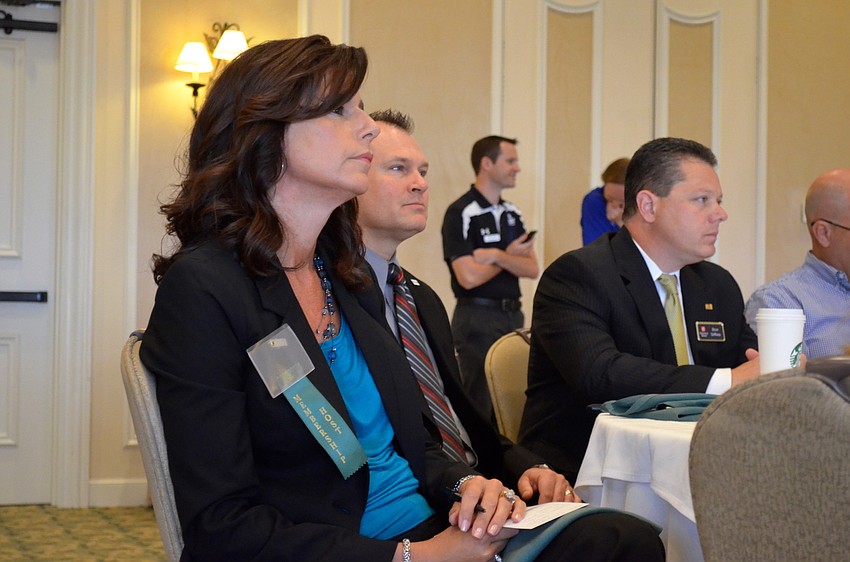 Kathleen Burrell, Michael Talerico and Dominic DiMaio enjoy the morning's optimistic message.