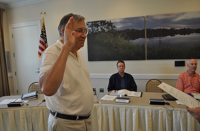 Jerry Twiggs is sworn in by Jess Mears, the clerk to the CDD boards.