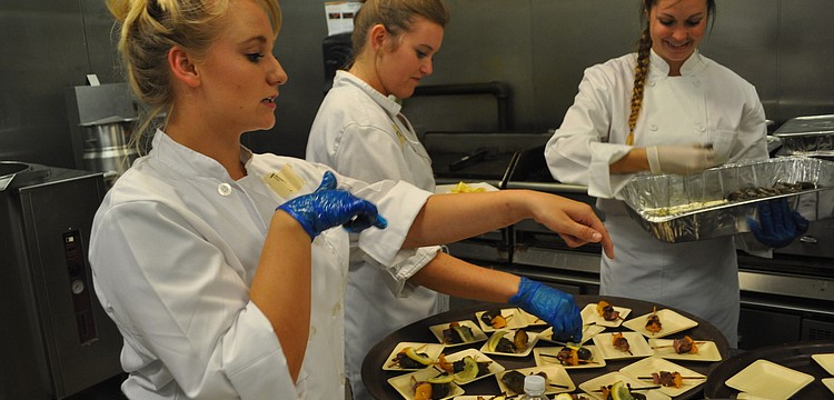 Hospitality students Katey Witt, Brittany Figlow and Julieah Sinkler prepare lamb kebabs.