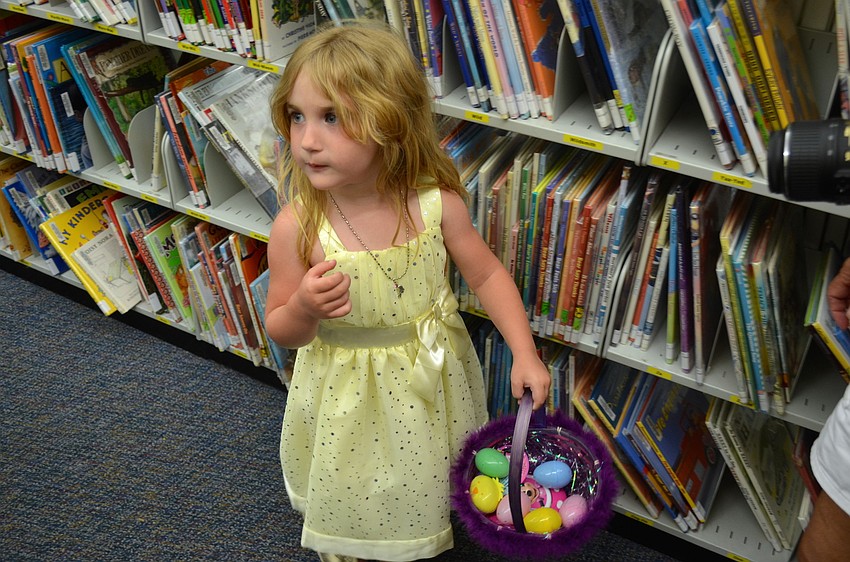 Three-year-old Kelly Sportsman searches for Easter eggs.