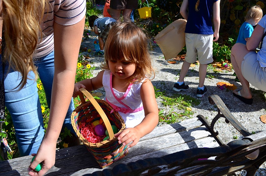 Children under 5 search for hidden eggs in the garden at Mar Vista.