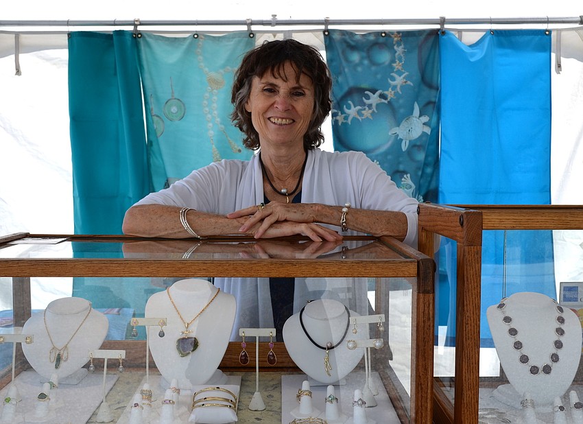 Alexis Barbeau smiles at her booth where sheâ€™s featuring her silver jewelry.