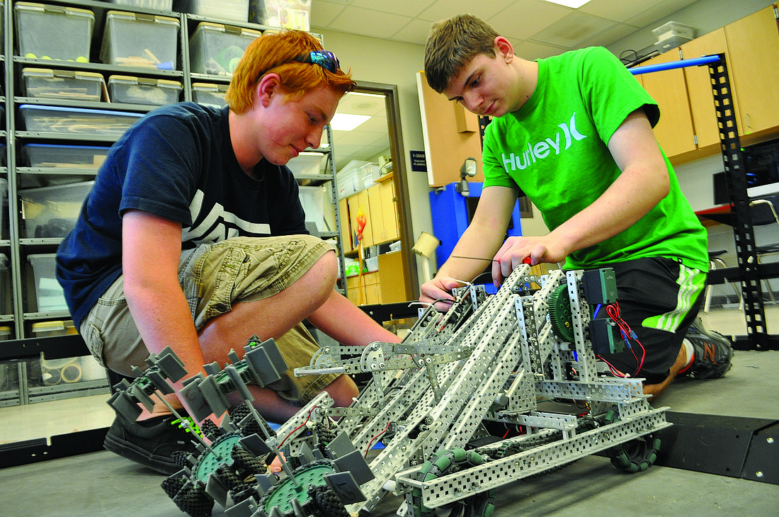 Evan Lynch and Chris Miller, both 13, work on a robot for the Vex robotics competition this week. Photo by Pam Eubanks