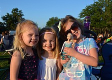 Macy McHugh, Olivia Byrd and Emmy Little pose with a â€œFrozenâ€ Barbie.