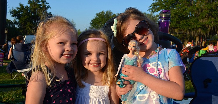 Macy McHugh, Olivia Byrd and Emmy Little pose with a â€œFrozenâ€ Barbie.