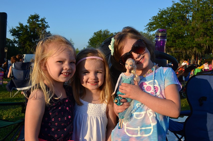 Macy McHugh, Olivia Byrd and Emmy Little pose with a â€œFrozenâ€ Barbie.