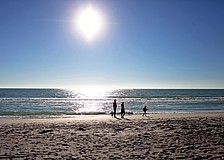 A family visiting from Massachusetts enjoys the sunshine on an afternoon walk along a Longboat Key beach on Tuesday, April 29.