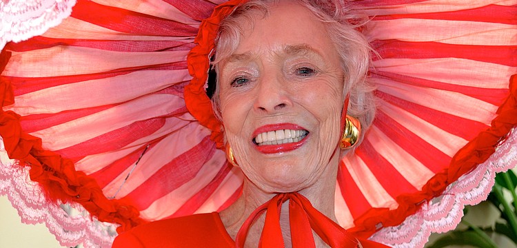 Dorothy Lawrence sports a red, lace hat for the party.