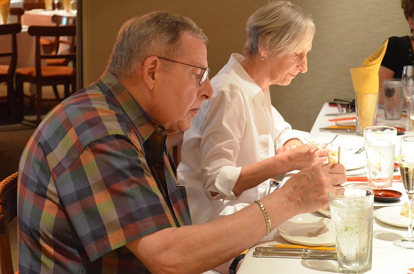 Werner Schuell demonstrates proper sushi etiquette â€” taking the roll in one bite.