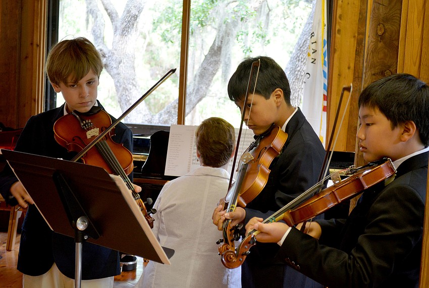 Nicholas, Thomas and Luke perform during the ceremony.