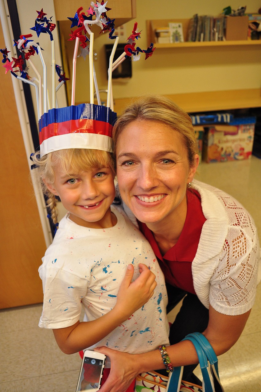 Taryn Eddy shows her mom, Erin, her hat, which is topped with 