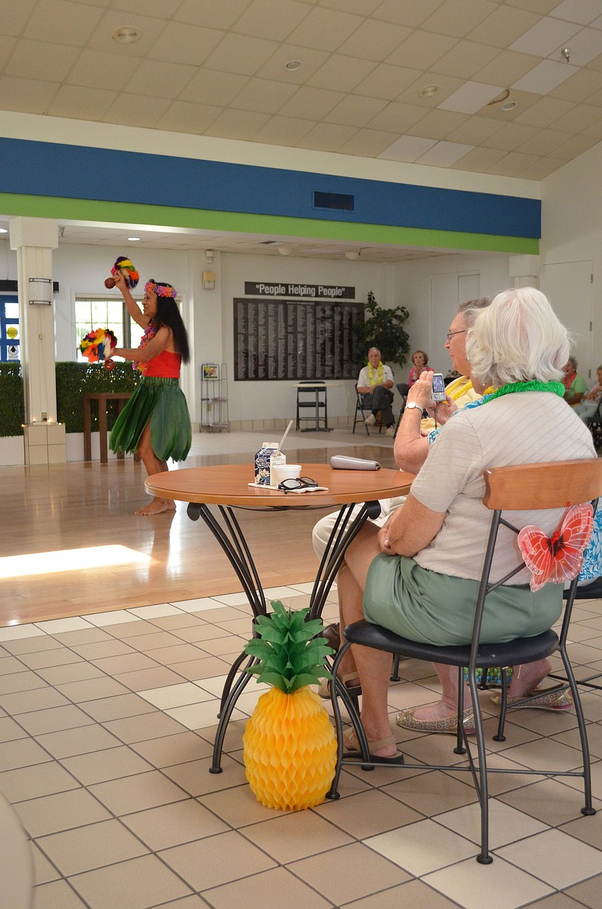 Jerry Griffiths watches as Otilla Massaro dances with the â€˜Uliâ€™uli