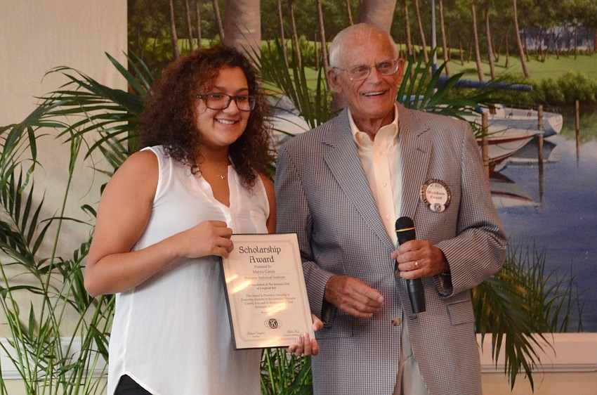 MTI student Mayra Garza accepts her scholarship certificate from Weldon Frost.