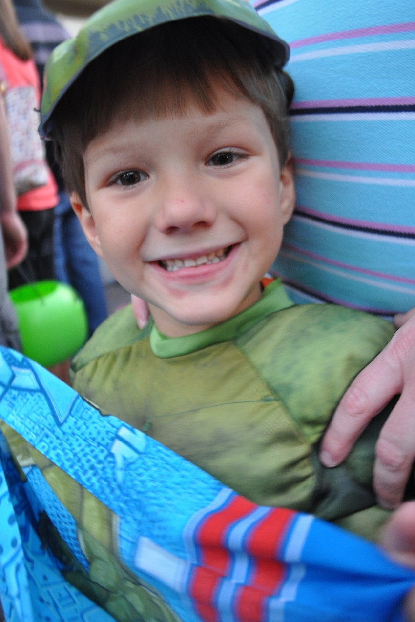 Maddox Eldredge, as the Hulk, filled his bag with candy, during the parade.