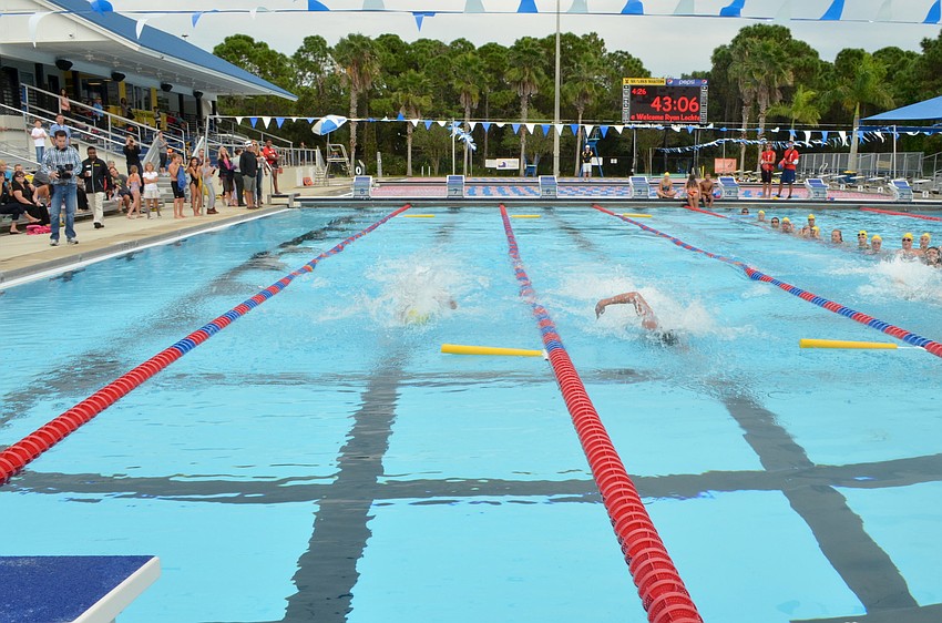 Senior Sharks Liam McKane and Alex Katz race Ryan Lochte in a 25-meter sprint Thursday, Oct. 24, at The Selby Aquatic Center.