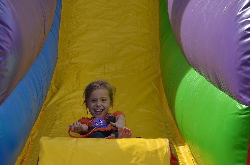 Madeline McAfee goes down the slide at the YMCAâ€™s Fall Festival.
