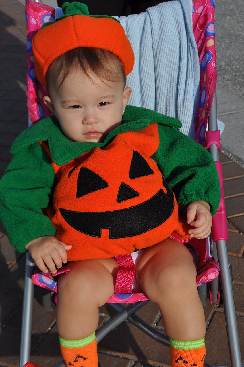 Aika Tsukiya, 1, relaxes while her mother gathers her treats.