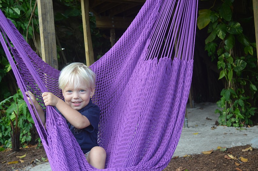 Carter Keel enjoys one of the colorful hammocks available to visitors.