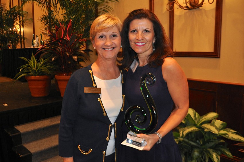 Vanessa Baugh crowns Violetta Huesman, who also brought home an iPad mini, Networking Queen.