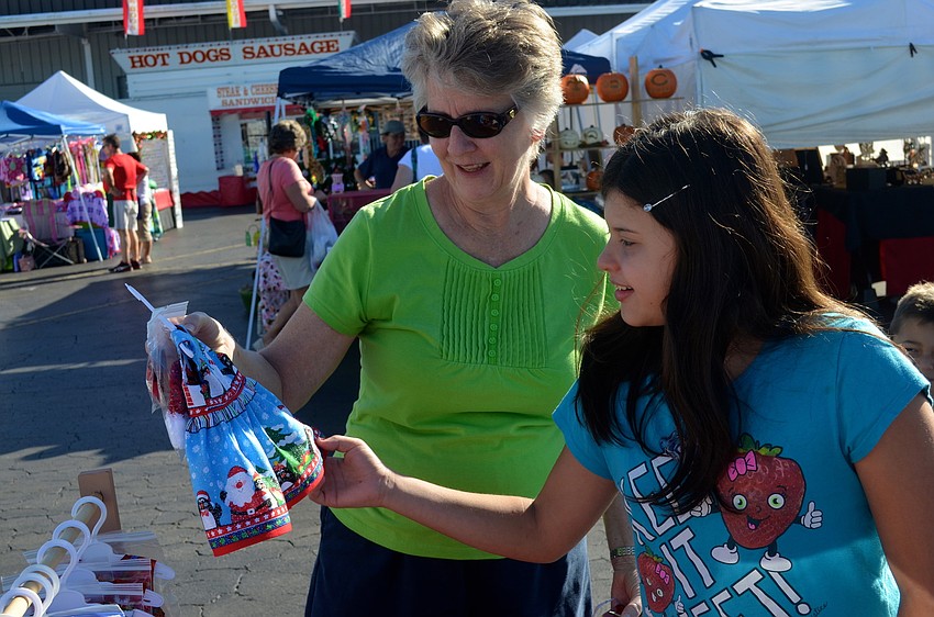 Linda Baker and her granddaughter Jaime, 11, pick out clothing for dolls.