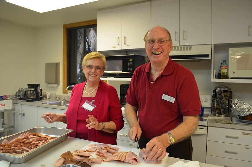 Pat and Reg Tays prepare the ham