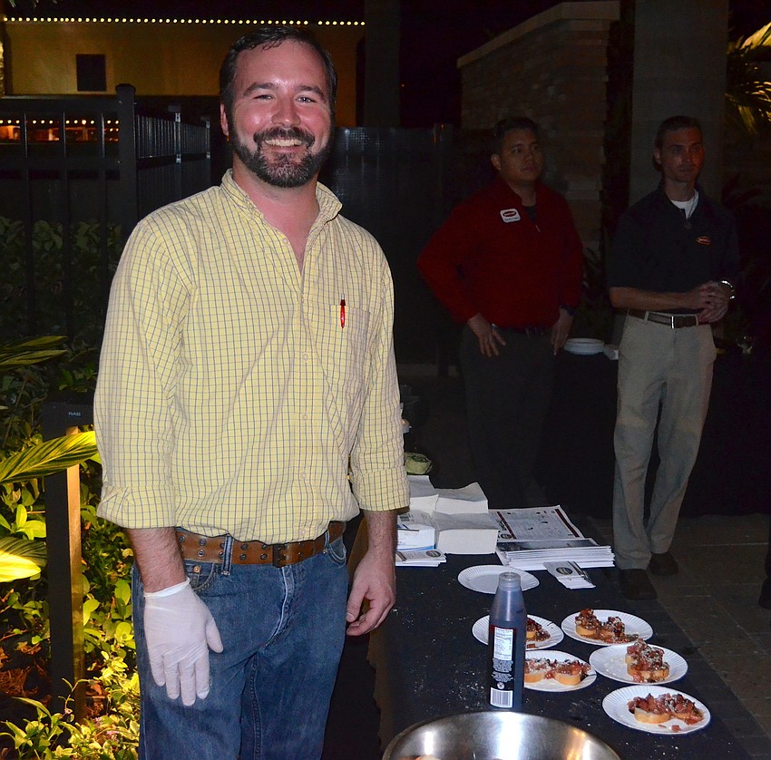 Jason Seelbach, of Truman's Tap and Grill, cooks munchies for party guests.