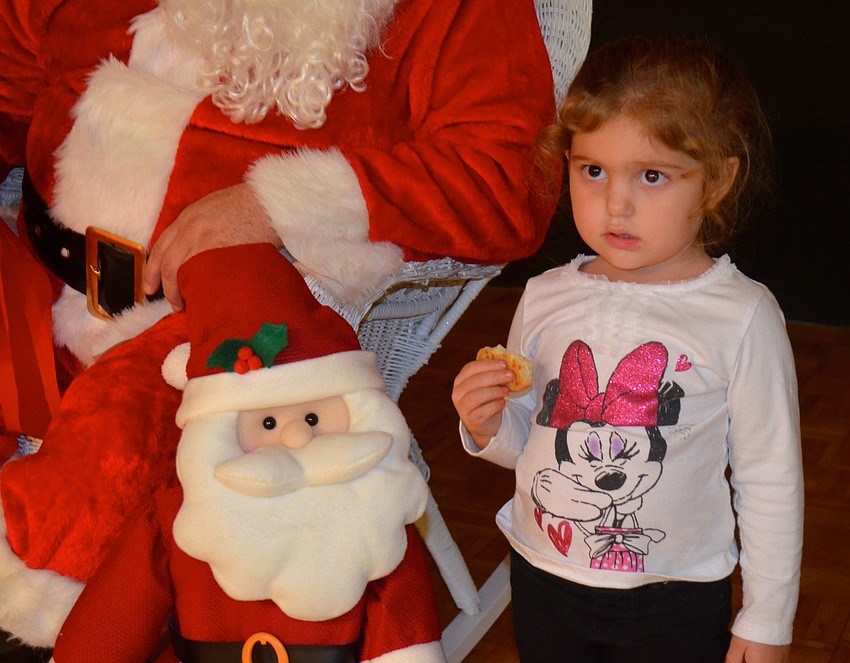 Alexis Degendice, 3, is unsure of the big man in the red suit.