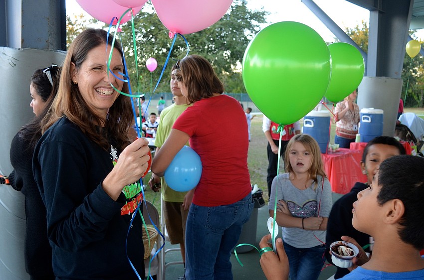 Chris-Anne Phelps helps inflate balloons for the students.