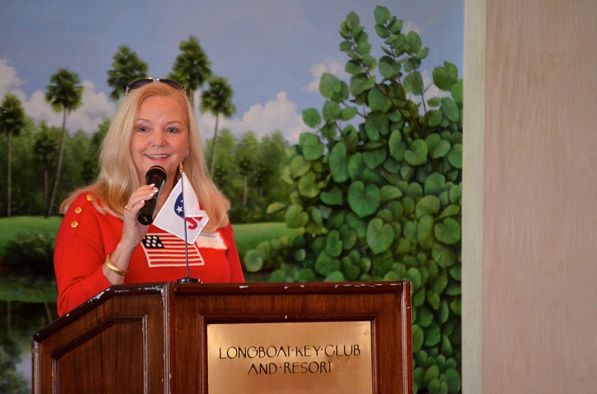 Phyllis Black makes club announcements before the debate.