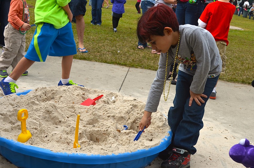 Gabriel Cuevas, 6, plays around in the sand.