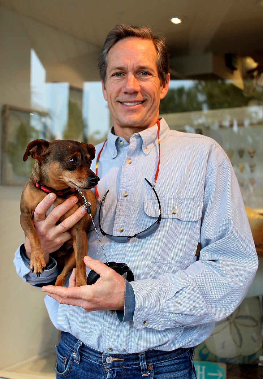 Gregg Newhuis explores St. Armands with his dog, Chico.