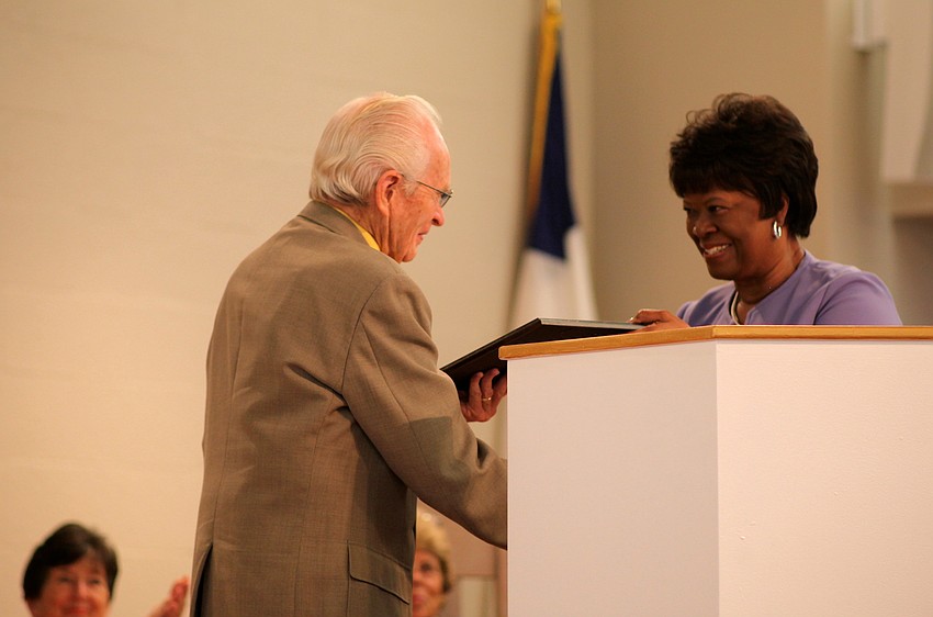 Dr. Jack Barnes accepts his award from Sandra Holley.