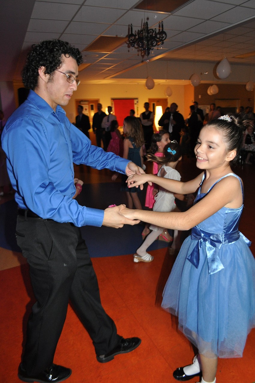 Frank Galambos twirls his cousin, Angelina Vazquez, around the dance floor.