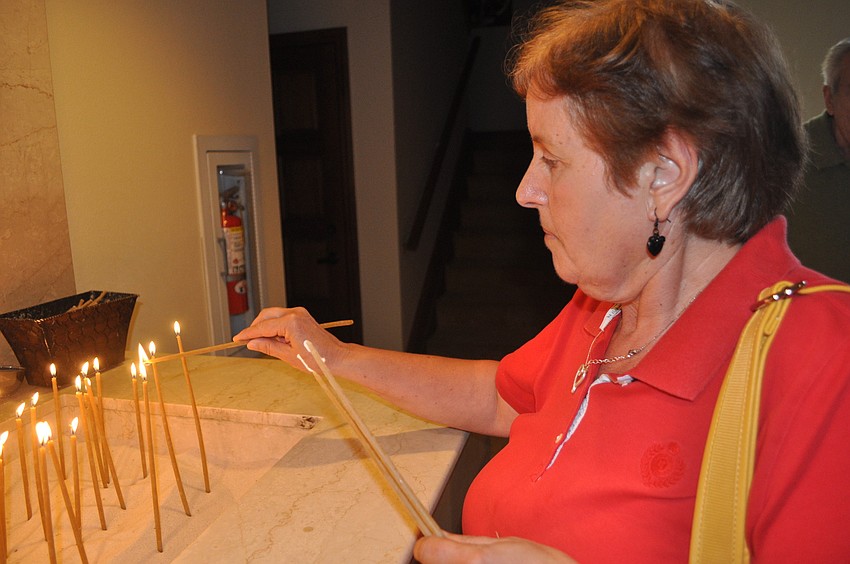 Zoey Grigoroff lit candles during a church tour in hopes for her wishes to be granted.