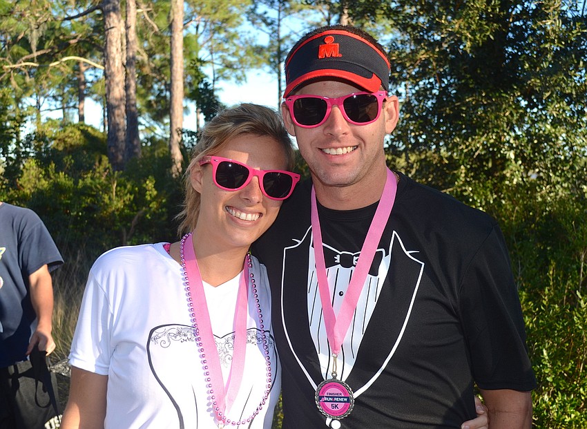 Natalie Thibeaut and Graham Cox show off their pink sunglasses.