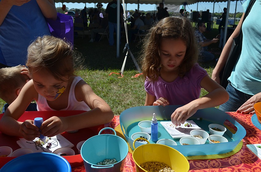 Zoe Motz and Julia Brytula work on arts and crafts.