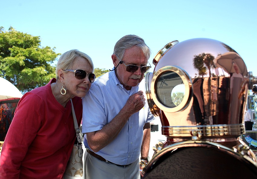 Keats and Ed Whitcraft appreciate Nicholas Tothâ€™s handmade helmet.