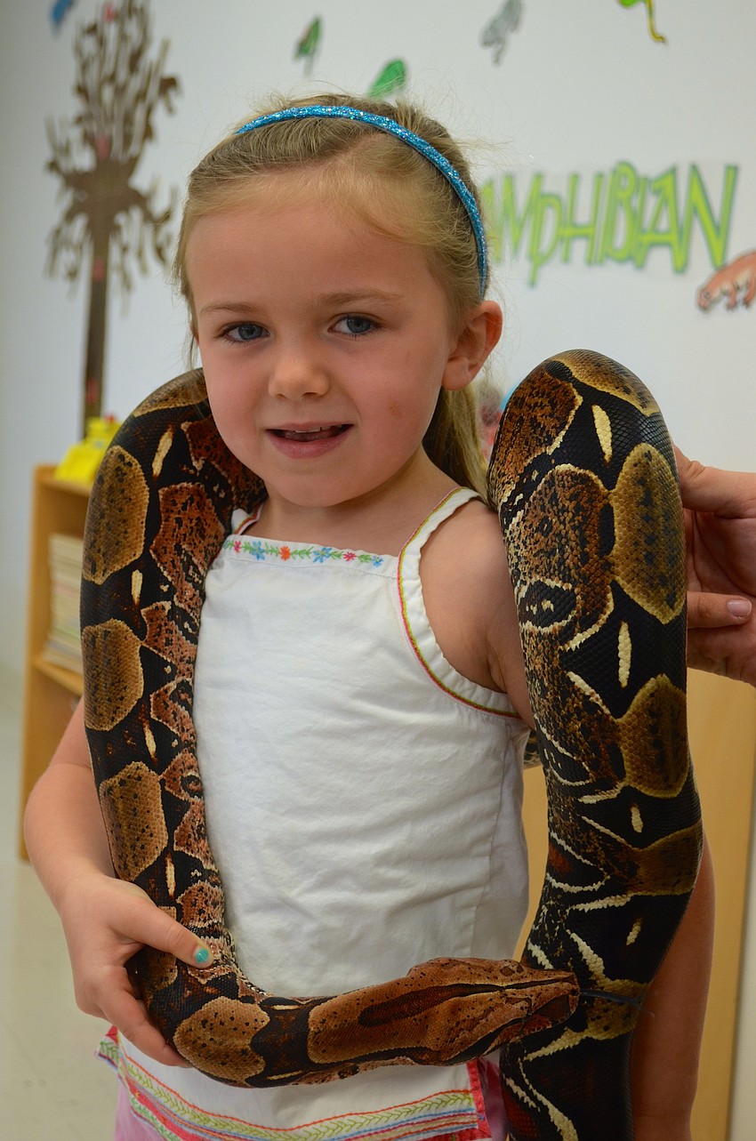 Meg Treager, 4, shows no fear holding a snake.